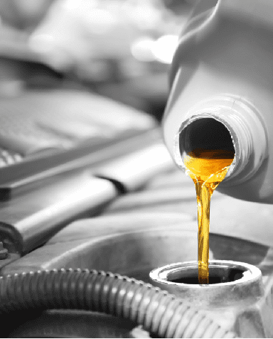 a pouring oil into a car engine